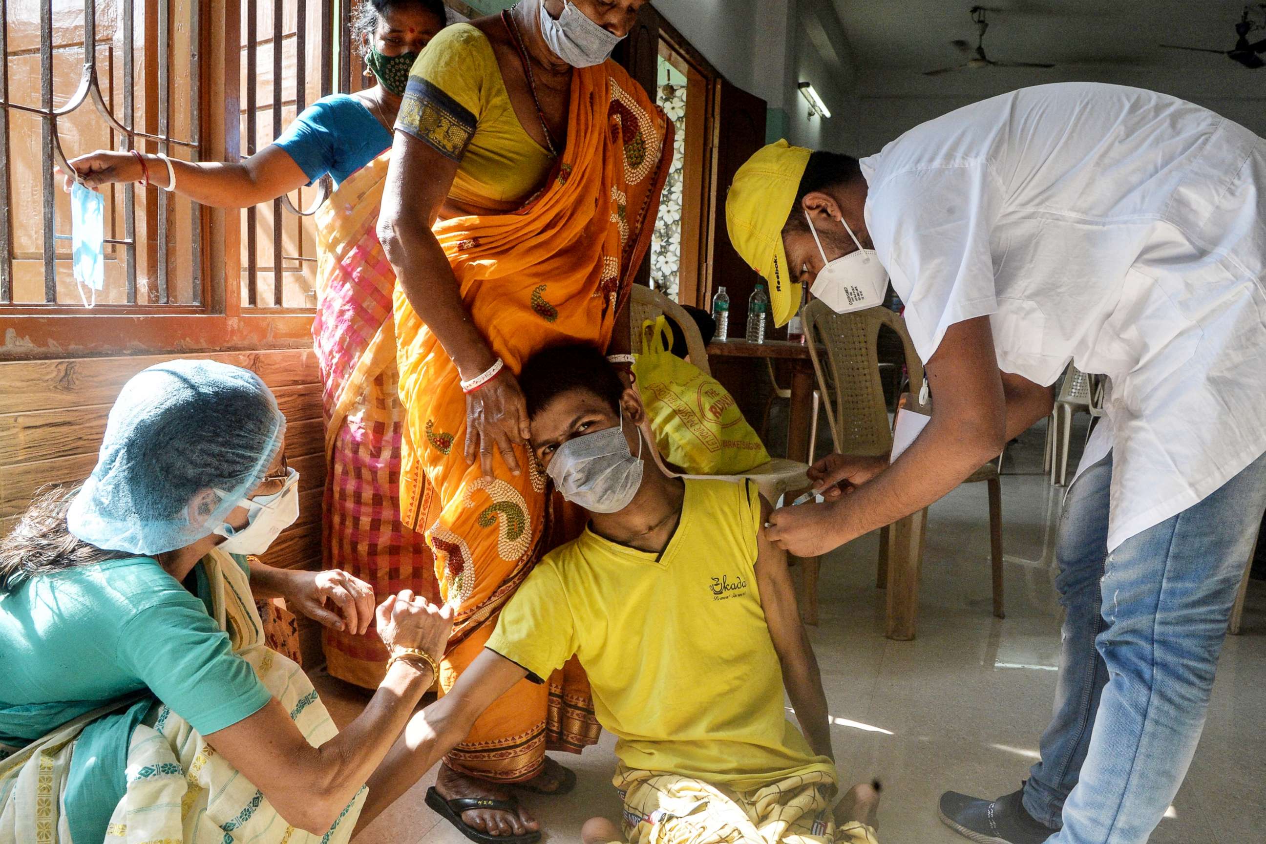 PHOTO: A health worker inoculates a youth with a dose of the Covid-19 vaccine during a vaccination drive in Siliguri, India on June 17, 2021. 