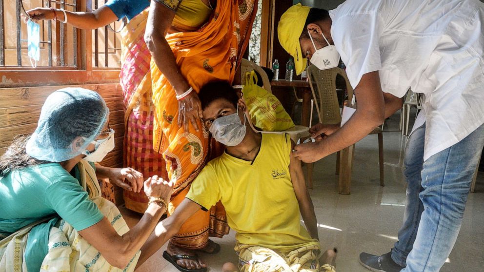 PHOTO: A health worker inoculates a youth with a dose of the Covid-19 vaccine during a vaccination drive in Siliguri, India on June 17, 2021. 