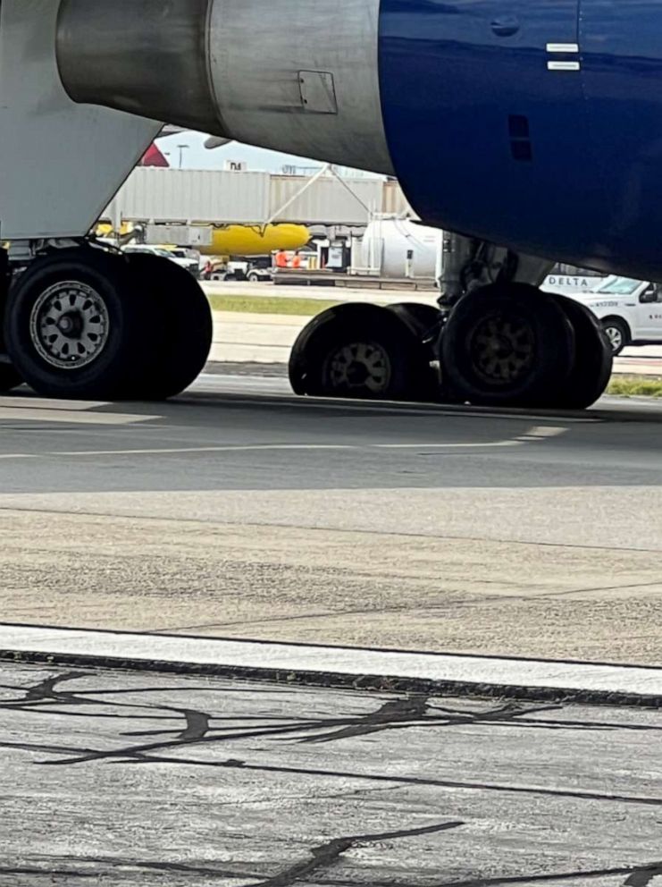 PHOTO: Passengers on a Delta flight make an emergency evacuation at Hartsfield-Jackson Atlanta International Airport on Aug. 2, 2023, after one tire popped and another was shredded as they landed.