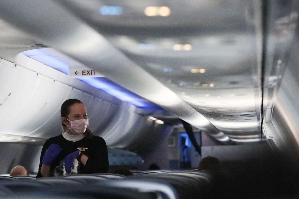 PHOTO: A flight attendant serves a snack on a Baltimore-bound Delta flight to Hartsfield-Jackson Atlanta International Airport on April 20, 2020, in Linthicum Heights, Md. 