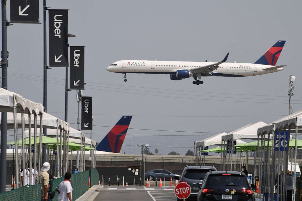 PHOTO: A Delta Airline plane passes above Los Angeles International Airport in Los Angeles, Aug. 20, 2020.