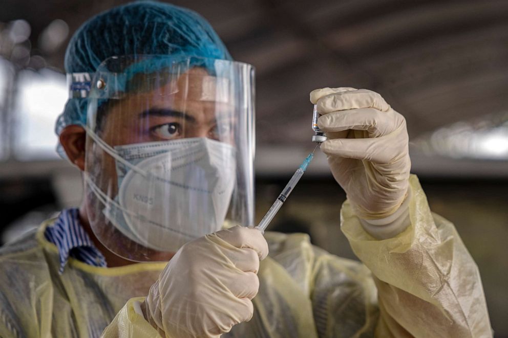 PHOTO: MANILA, PHILIPPINES - JULY 20: A healthcare worker prepares a shot of Sinovac Biotech's CoronaVac COVID-19 vaccine during a mass vaccination for public transportation workers on July 20, 2021 in Manila, Philippines. 