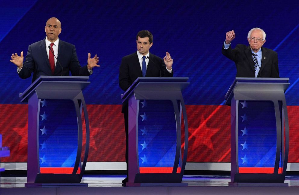 PHOTO: Democratic presidential hopefuls Cory Booker, Pete Buttigieg and Sen. Bernie Sanders gesture during the third Democratic primary debate of the 2020 presidential campaign season in Houston, Sept. 12, 2019.