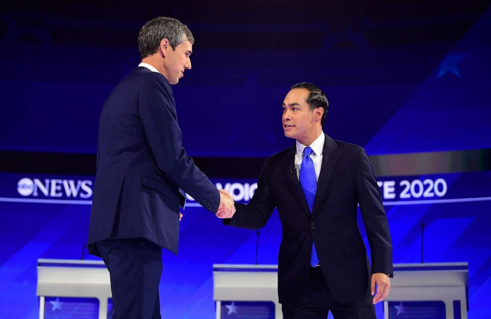 PHOTO: Democratic presidential hopefuls Former Texas Representative Beto O'Rourke  and Former housing secretary Julian Castro shake hands as they arrive on stage for the third Democratic primary debate in Houston, Sept. 12, 2019.