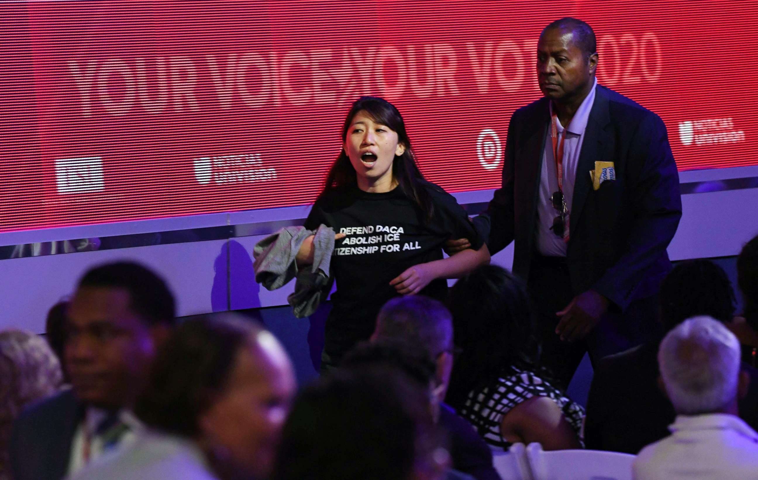 PHOTO: A protester is escorted during the third Democratic primary debate of the 2020 presidential campaign season in Houston, Sept. 12, 2019.
