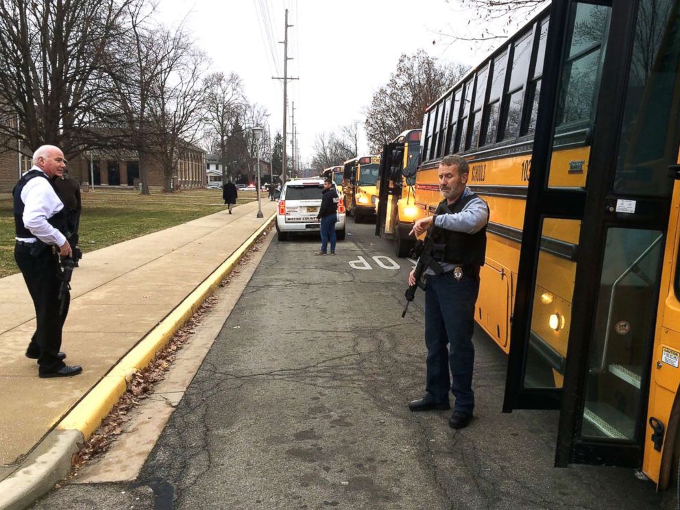 PHOTO: Buses wait to take students to Civic Hall at Richmond High School for parents to pick them up after a report of shots being fired at Dennis Intermediate School in Richmond, Ind., Dec.13, 2018.
