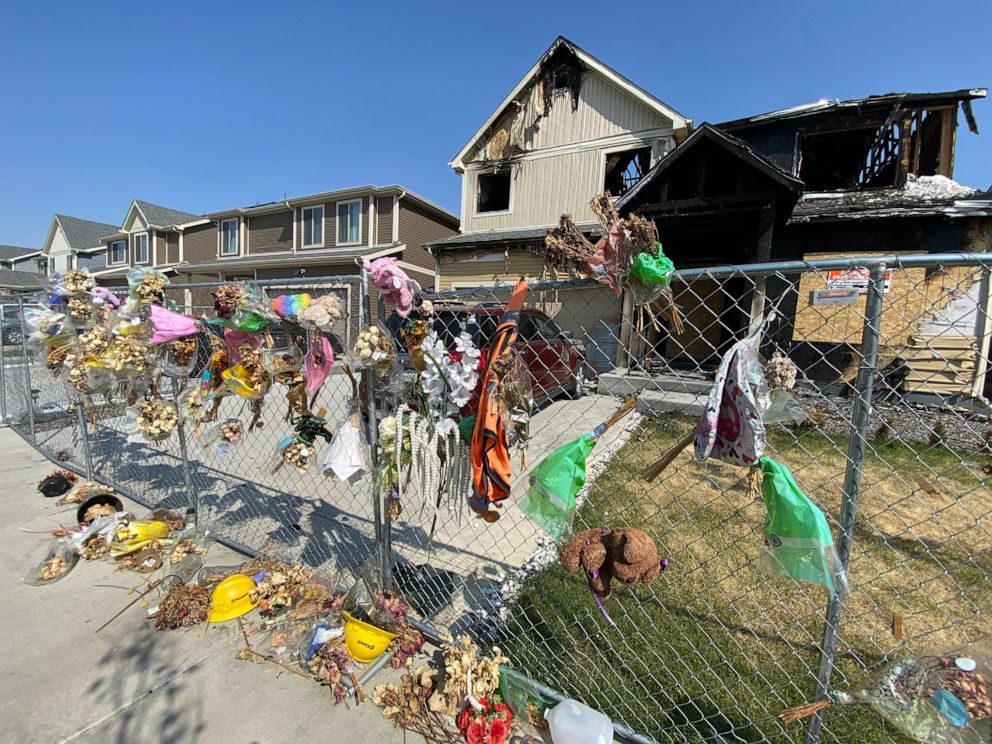 PHOTO: Flowers and stuffed animals line a chain-link fence outside a burned home in Denver. Five members of the Diol family died in an August fire that police determined to be arson.