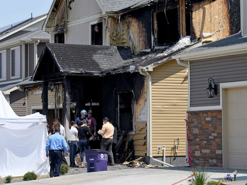 PHOTO: Investigators stand outside a house where five people were found dead after a fire in suburban Denver, Aug. 5, 2020. 