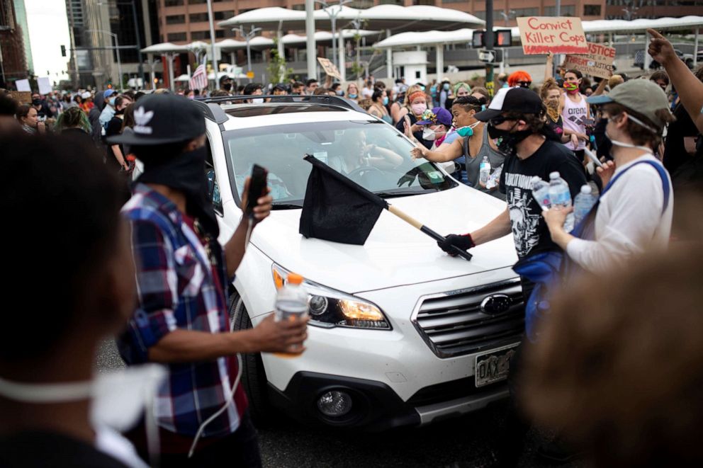 PHOTO: A driver tries to get through the streets as protesters rally against the death in Minneapolis police custody of George Floyd, in Denver, May 30, 2020.