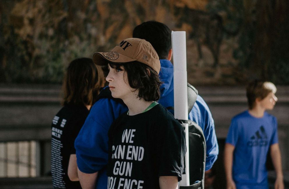 PHOTO: Students gather before the beginning of the March for Our Lives event, March 24, 2018 in Denver. Students were given t-shirts reading, "We can end gun violence" as well as free pins.