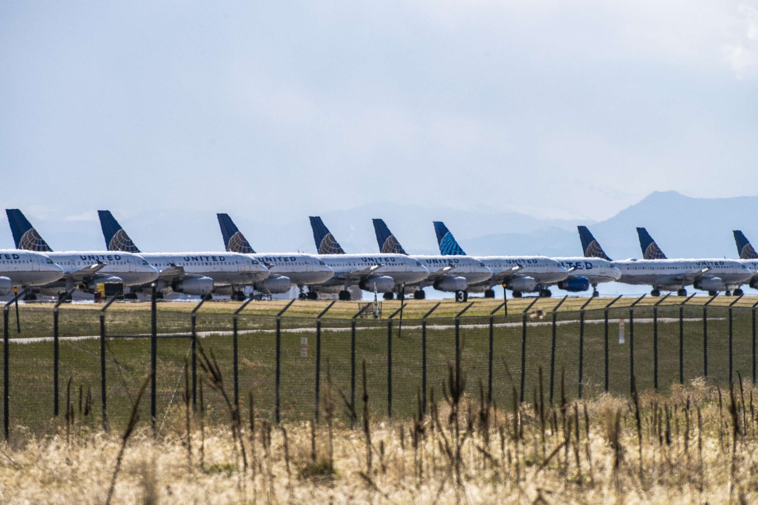 PHOTO: DENVER, CO - APRIL 22: United Airlines planes sit parked on a runway at Denver International Airport as the coronavirus pandemic slows air travel on April 22, 2020 in Denver, Colorado. 