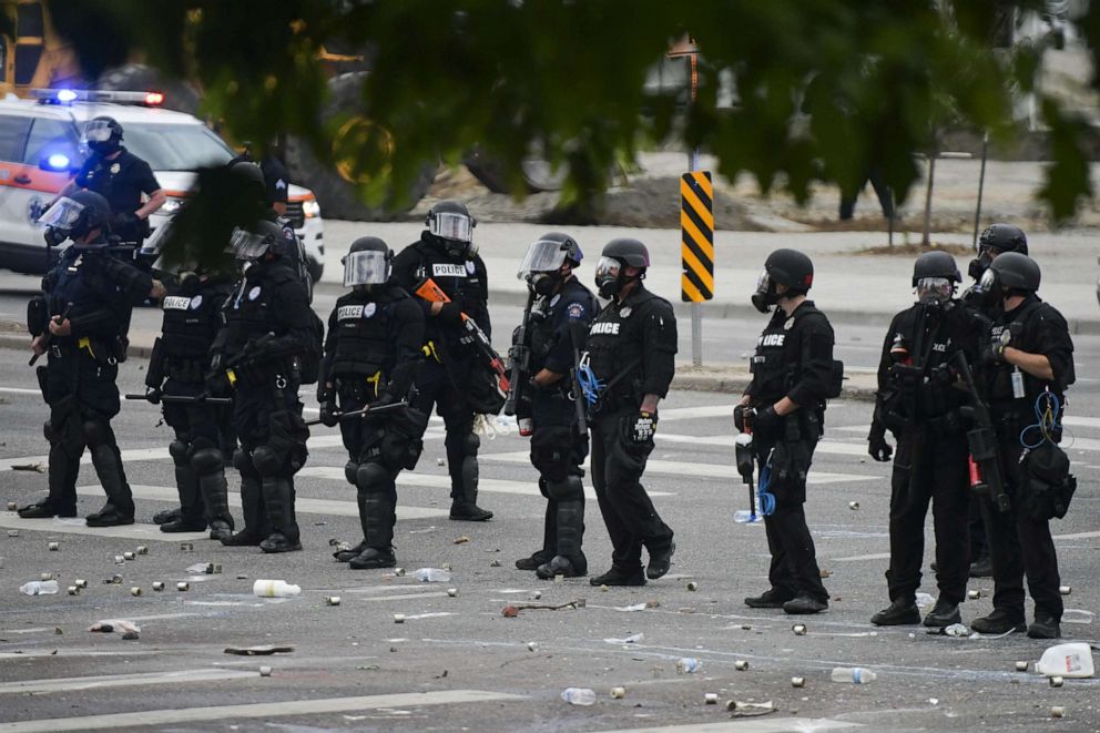 PHOTO: In this May 30, 2020, file photo, police officers stand in a line next to the Colorado State Capitol as protests against the death of George Floyd continue in Denver.