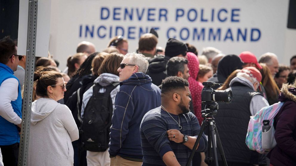 PHOTO: Parents wait for students to be walked out after as shooting at Denver East High School, March 22, 2023, in Denver.