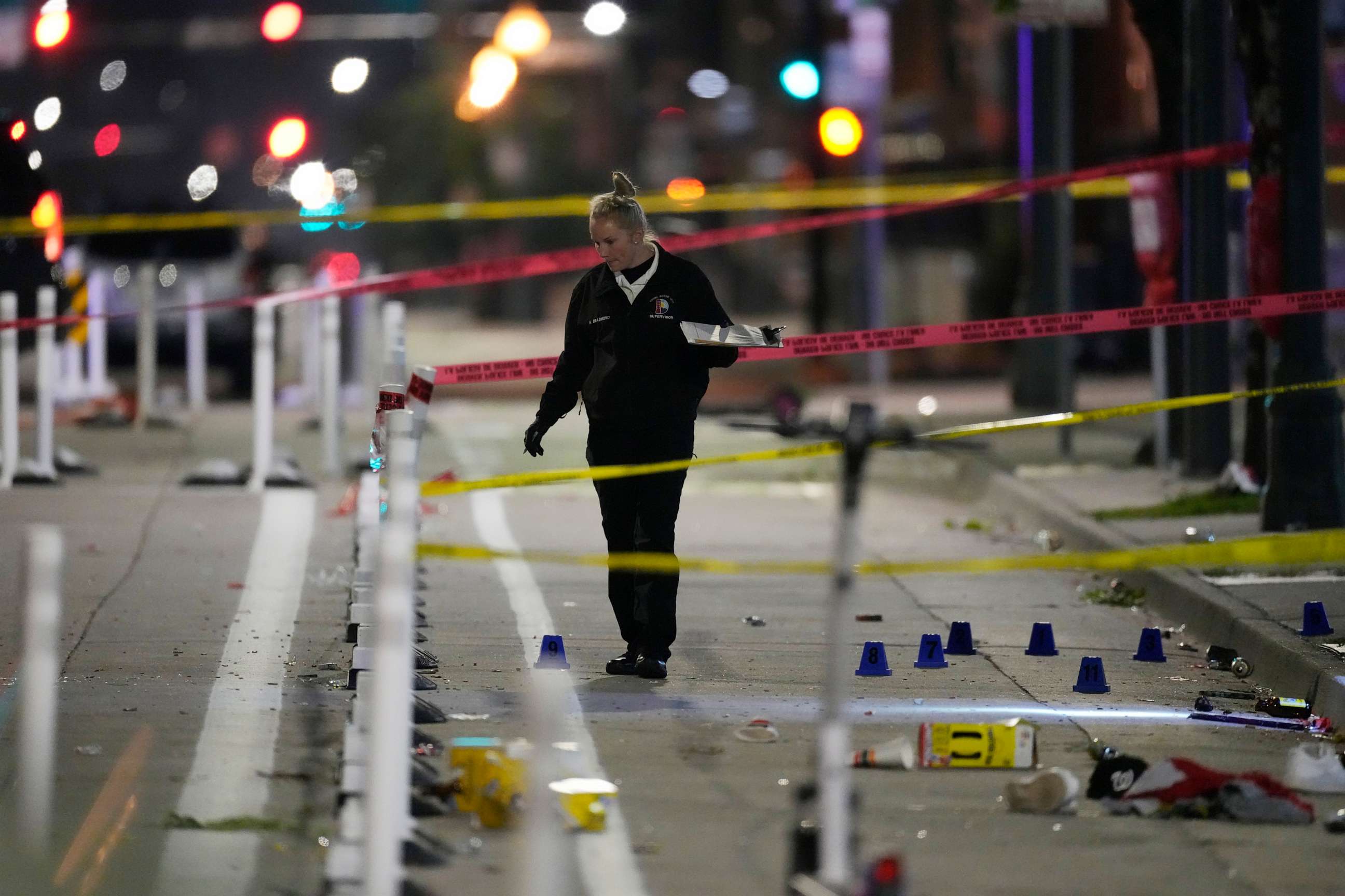 PHOTO: Denver Police Department investigator works the scene of a mass shooting along Market Street between 20th and 21st avenues during a celebration after the Denver Nuggets won the team's first NBA Championship early Tuesday, June 13, 2023, in Denver.
