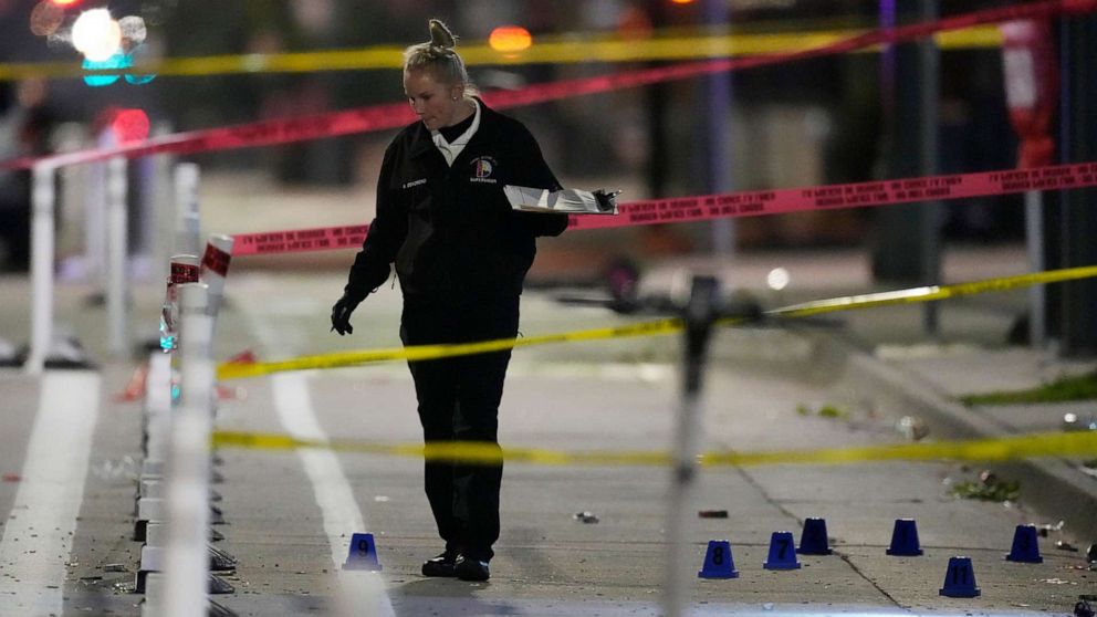 PHOTO: Denver Police Department investigator works the scene of a mass shooting along Market Street between 20th and 21st avenues during a celebration after the Denver Nuggets won the team's first NBA Championship early Tuesday, June 13, 2023, in Denver.