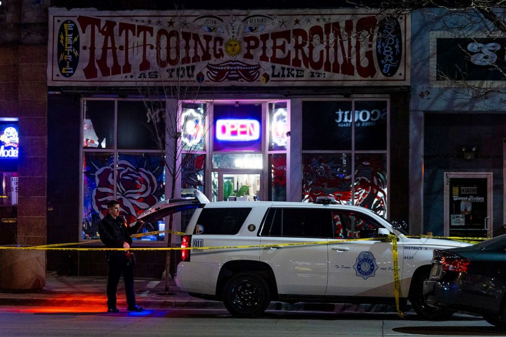 PHOTO: Police officers stand outside Sol Tribe tattoo shop on Broadway on Dec. 27, 2021 in Denver.
