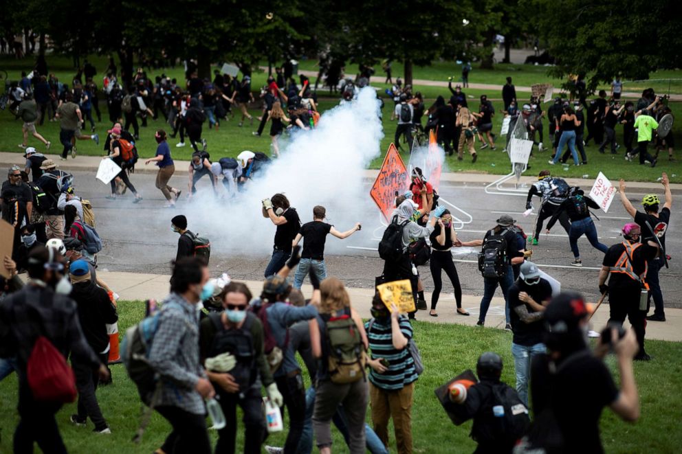 PHOTO: Protesters run after police fired tear gas during a rally in Denver against the death of George Floyd, May 30, 2020.