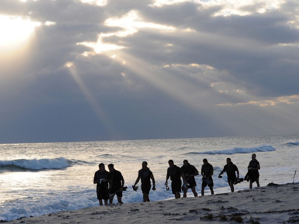 PHOTO: Members of SEAL Team 18 swim into the ocean to release the ashes of fellow SEALs who have died within the last year during a ceremony at Fort Pierce Beach, Fla., Nov. 7, 2010.