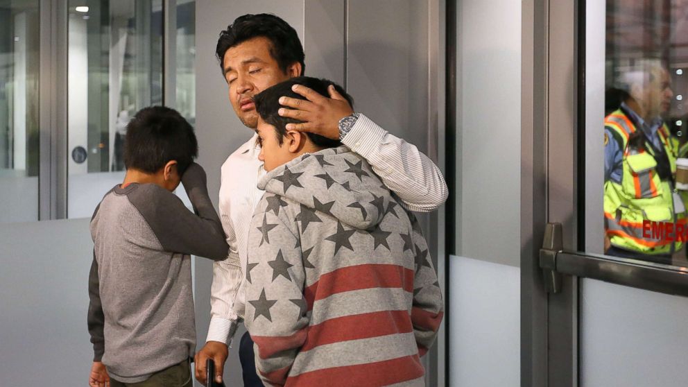 PHOTO: Jesus Lara Lopez, 37, of Willard, Ohio, comforts his sons before he is deported back to Mexico, July 18, at Cleveland Hopkins International Airport.