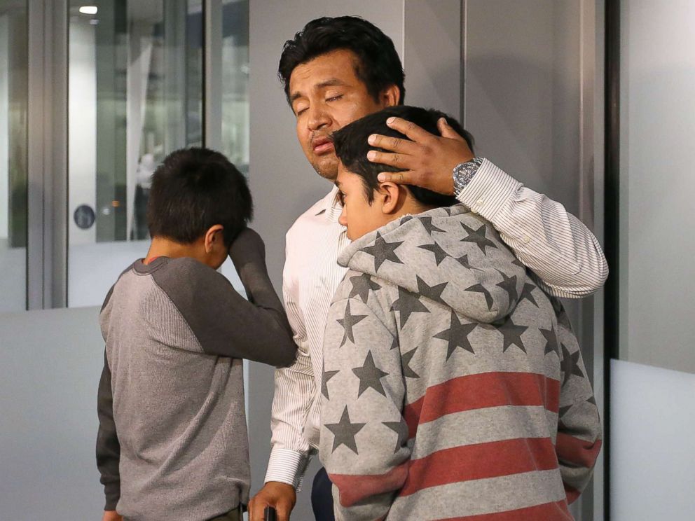 PHOTO: Jesus Lara Lopez, 37, of Willard, Ohio, comforts his sons before he is deported back to Mexico, July 18, at Cleveland Hopkins International Airport.