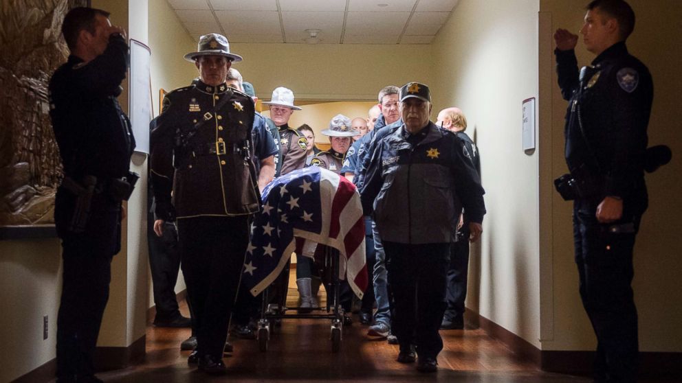 Officers and medical staff take part in a procession for officer Daniel McCartney, of Yelm, at St. Joseph Medical Center in Tacoma, Wash., Jan. 8, 2018.