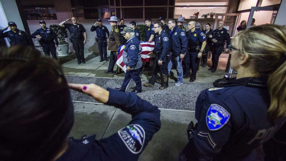 Officers and medical staff take part in a procession for officer Daniel McCartney, of Yelm, at St. Joseph Medical Center in Tacoma, Wash., Jan. 8, 2018.