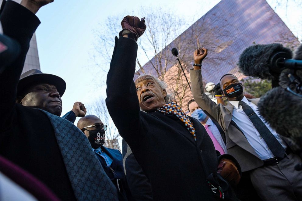 PHOTO: Philonise Floyd, brother of George Floyd, wears a mask reading "8:46" as he is joined by Attorney Benjamin Crump and Reverend Al Sharpton and other family and supporters in raising their fists outside the courthouse in Minneapolis, March 29, 2021.