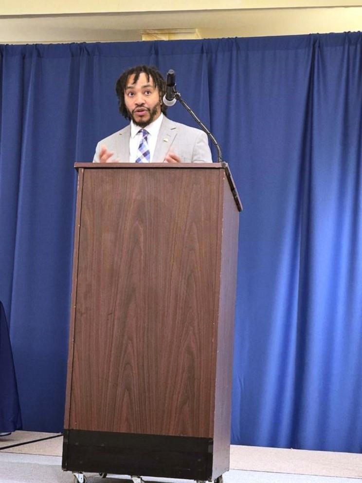 PHOTO: De'Shawn Washington, 2024 MA Teacher of the Year, delivers a speech on teacher retention and recruitment to an audience of MA Superintendents and School Committee Board members at the M.A.S.S/M.A.S.C. Conference, Nov. 8, 2024, in Hyannis, Mass.