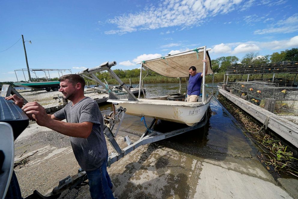 PHOTO: Charles Russ and Allan Bergeron pull their boat from the water after pulling their crab traps from Bayou Dularge in anticipation of Hurricane Delta, expected to arrive along the Gulf Coast later this week, in Theriot, La., Oct. 7, 2020.