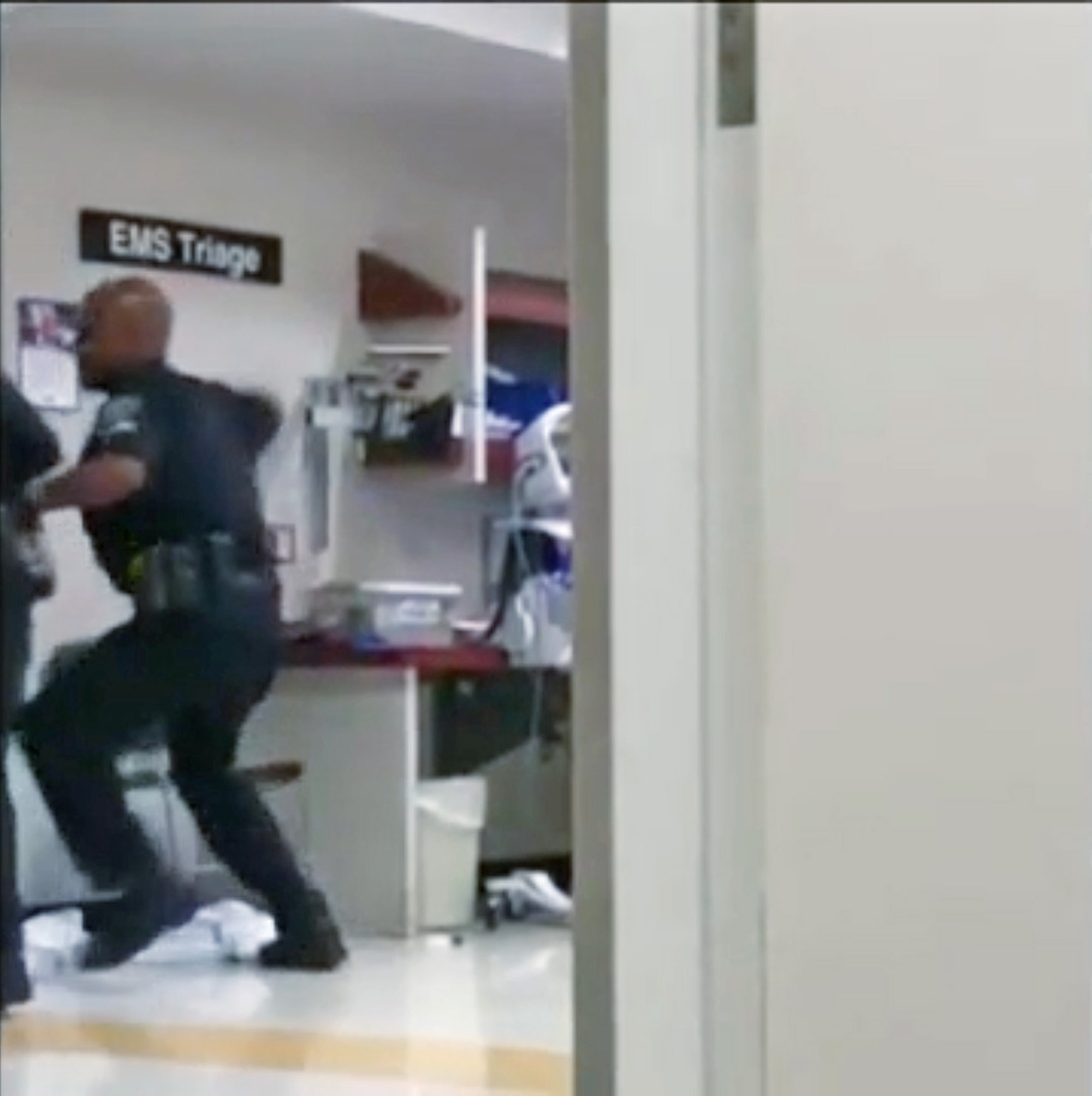 PHOTO: An image made from cell-phone video appears to show a Detroit police officer punching a naked and apparently emotionally disturbed woman at Detroit Receiving Hospital, Aug. 1, 2018. 