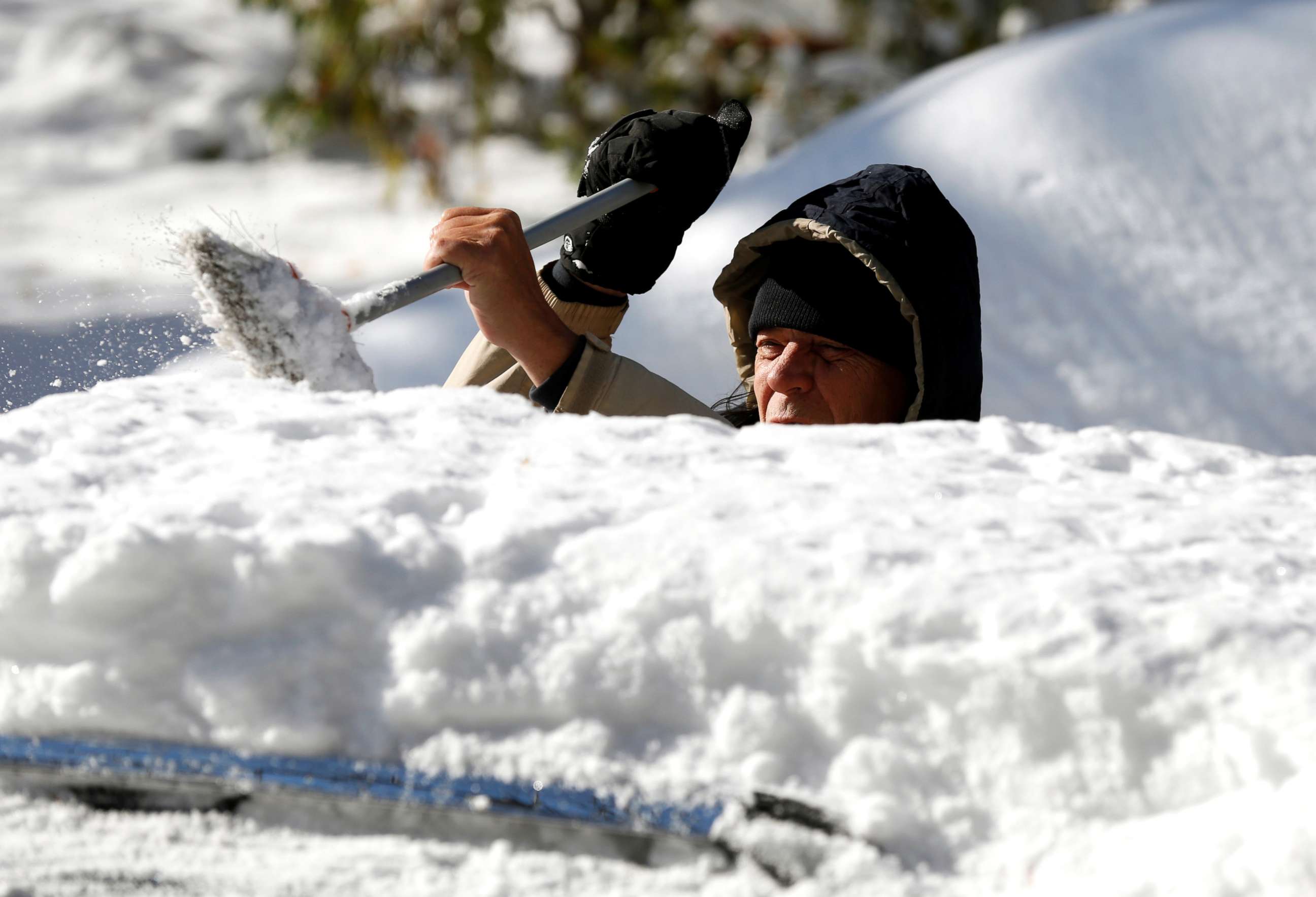 PHOTO: A man cleans the snow from the top of his vehicle in Detroit, Michigan, Nov. 12, 2019.