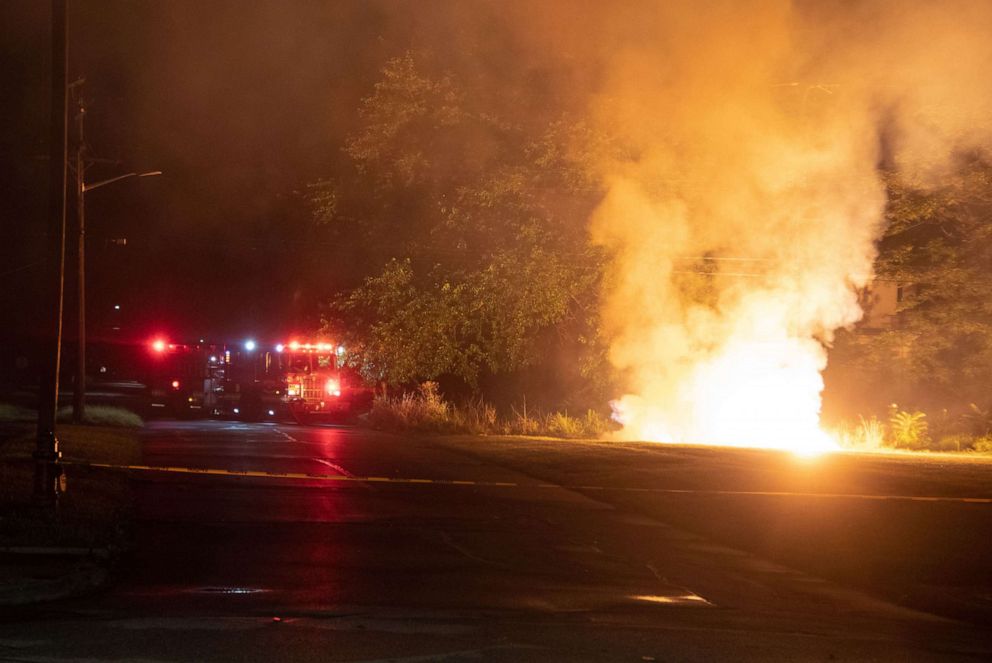 PHOTO: Detroit Fire Fighters control a downed power line caused by extreme winds on July 24, 2021,  from a severe thunderstorm that rolled through the city and also caused severe flooding of roads and homes.