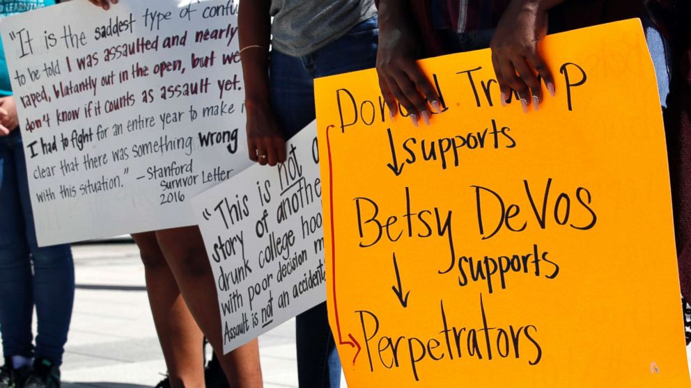 People gather to protest proposed changes to Title IX before a speech by Education Secretary Betsy DeVos, Sept. 7, 2017, at George Mason University Arlington, Va., campus.