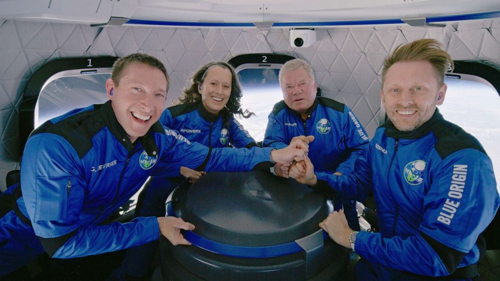 PHOTO: From left, Glen de Vries, Audrey Powers, William Shatner and Chris Boshuizen pose for a photo during the Blue Origin New Shepard mission NS-18 suborbital flight near Van Horn, Texas, Oct. 13, 2021.