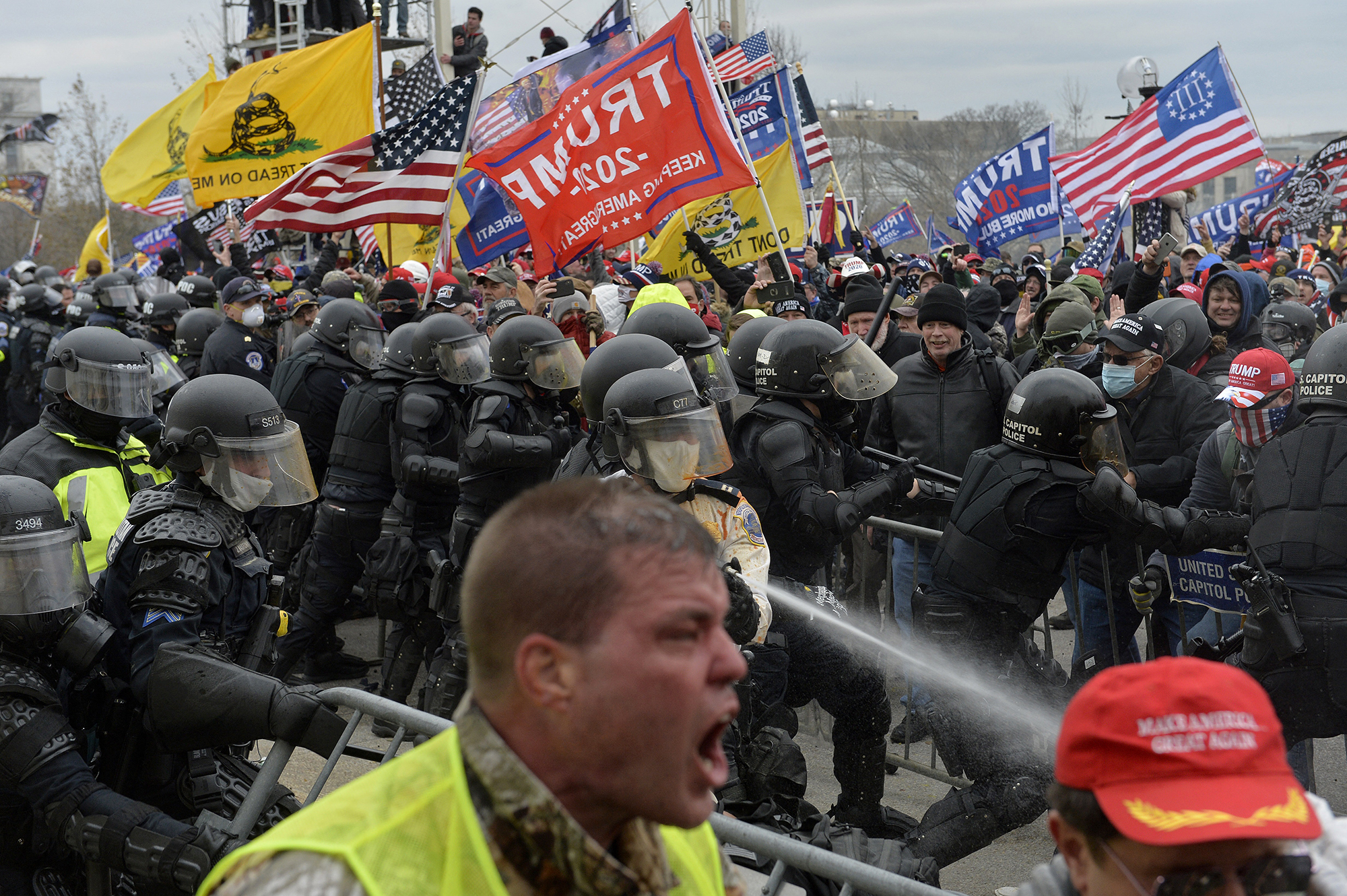 PHOTO: Trump supporters brandishing Three Percenter and other militia group flags clash with police and security forces as people try to storm the Capitol in Washington, Jan 6, 2021.
