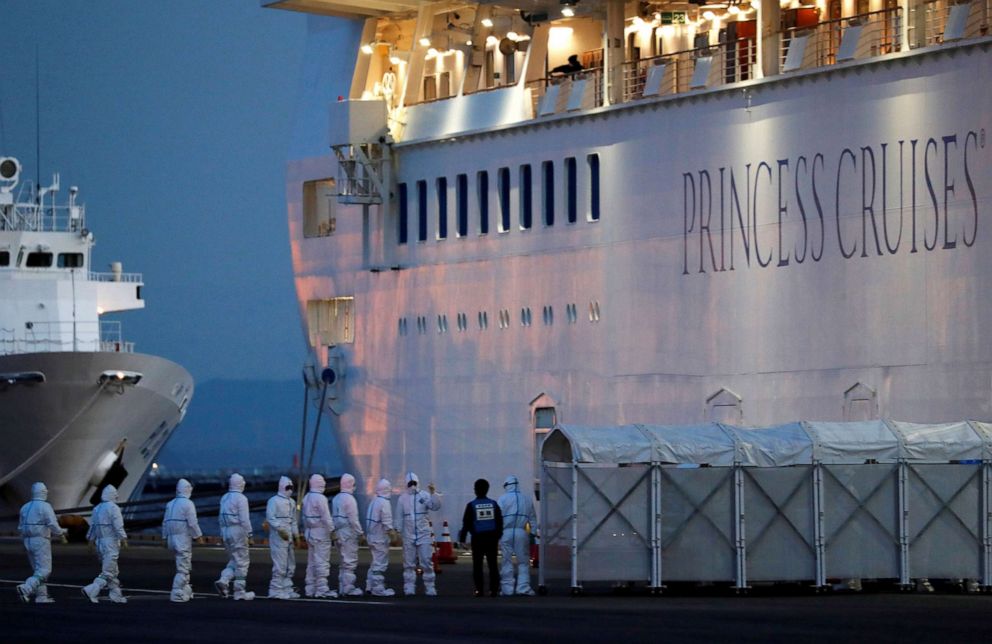 PHOTO: Officers in protective gear enter the cruise ship Diamond Princess to transfer a patient to the hospital after the ship arrived at Daikoku Pier Cruise Terminal in Yokohama, south of Tokyo, Feb. 7, 2020.