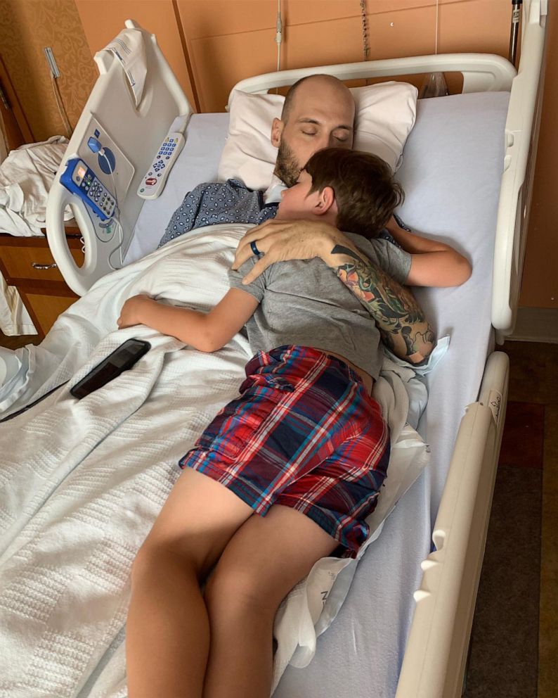 PHOTO: Golden Knight Sergeant First Class Dick Young in the hospital with his son after Dick was injured during a night jump on February 12, 2019.