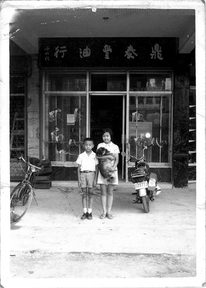 PHOTO: Young Yang Ji-Hua standing in front of the cooking oil shop, circa 1960, in Taiwan.