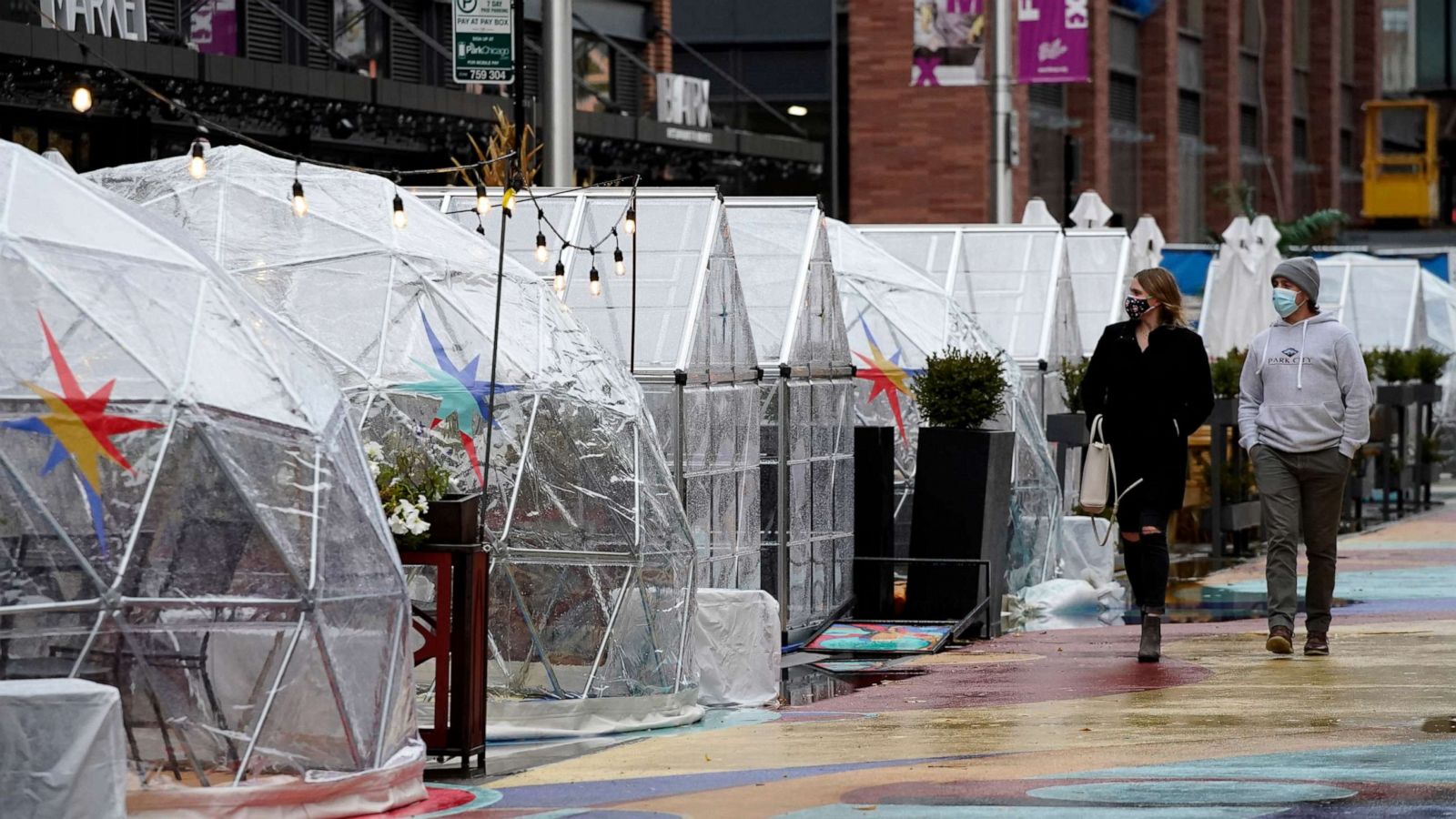 PHOTO: FILE - In this Oct. 18, 2020 file photo, people walk by outdoor plastic dining bubbles on Fulton Market in Chicago. Illinois set another single-day record for coronavirus infections Tuesday, Nov. 10, 2020.