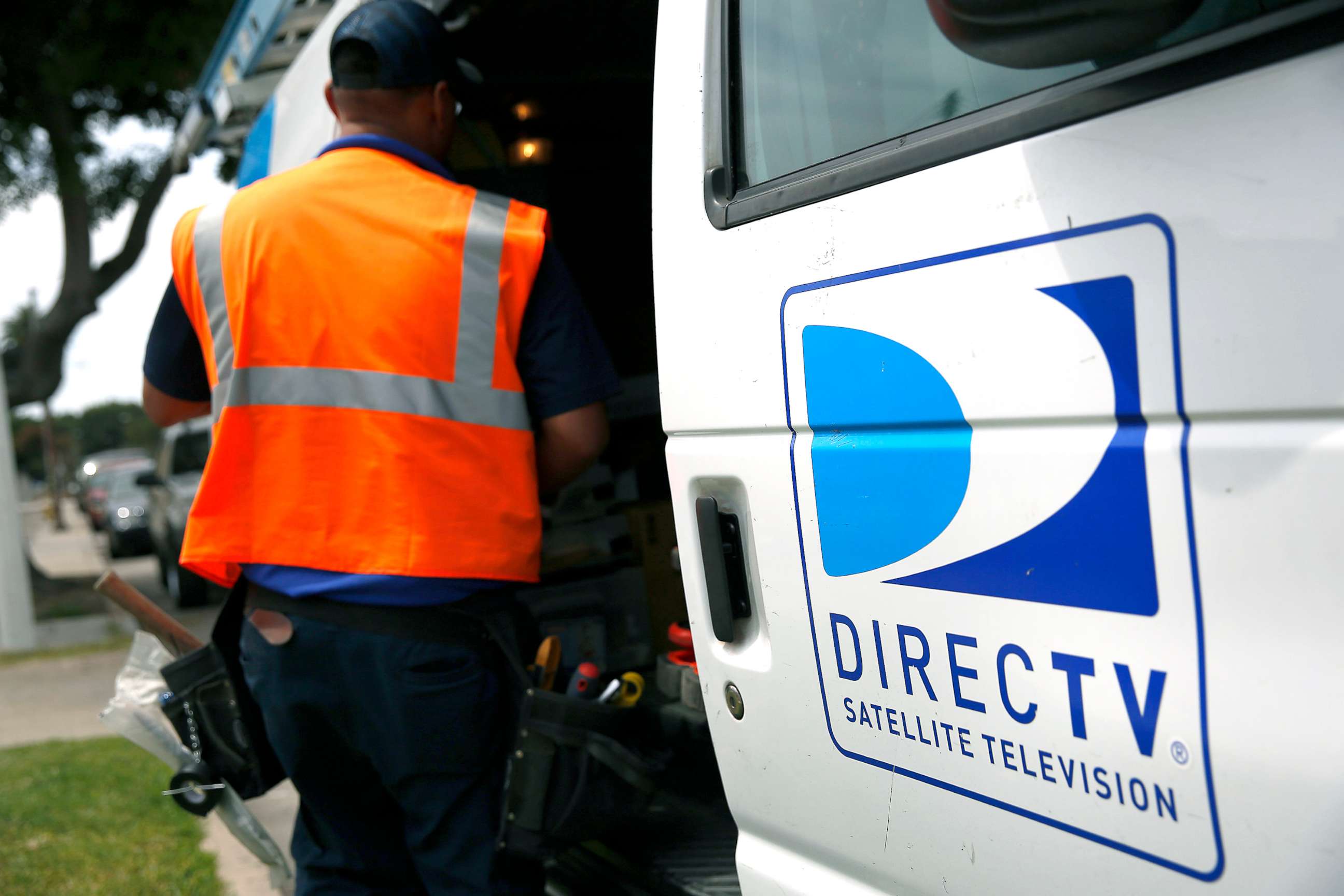 PHOTO: The DirecTV logo is seen as a technician stores equipment in a service truck after installing a new satellite TV dish at an apartment building in Lynwood, Calif., May 5, 2014.