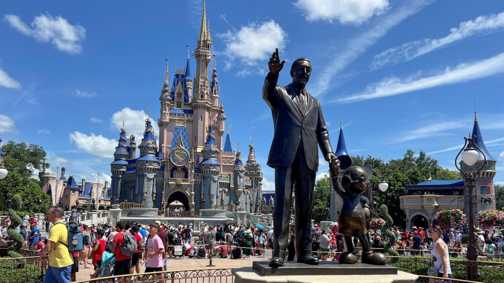 PHOTO: People gather at the Magic Kingdom theme park before the "Festival of Fantasy" parade at Walt Disney World in Orlando, Fla., July 30, 2022.