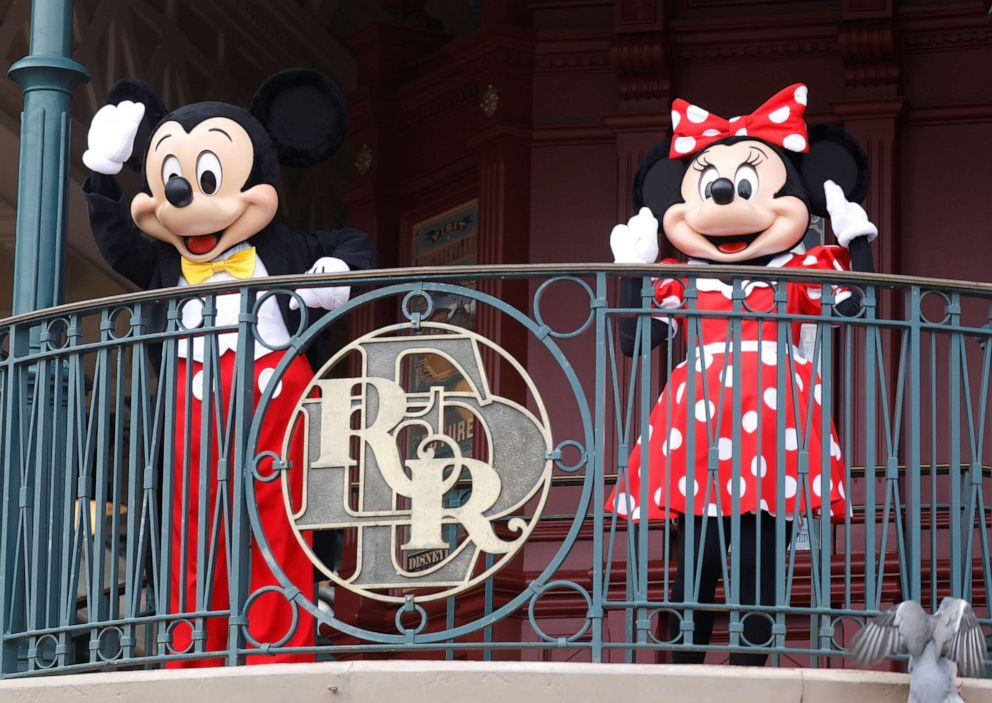 PHOTO: Disney characters Mickey Mouse and Minnie welcome visitors at Disneyland Paris as the theme park reopens its doors to the public in Marne-la-Vallee, in France,  July 15, 2020.