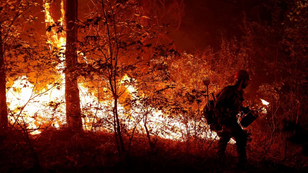 PHOTO: U.S. Forest Service firefighter Ben Foley lights backfires to slow the spread of the Dixie Fire, a wildfire near the town of Greenville, Calif. Aug. 6, 2021.