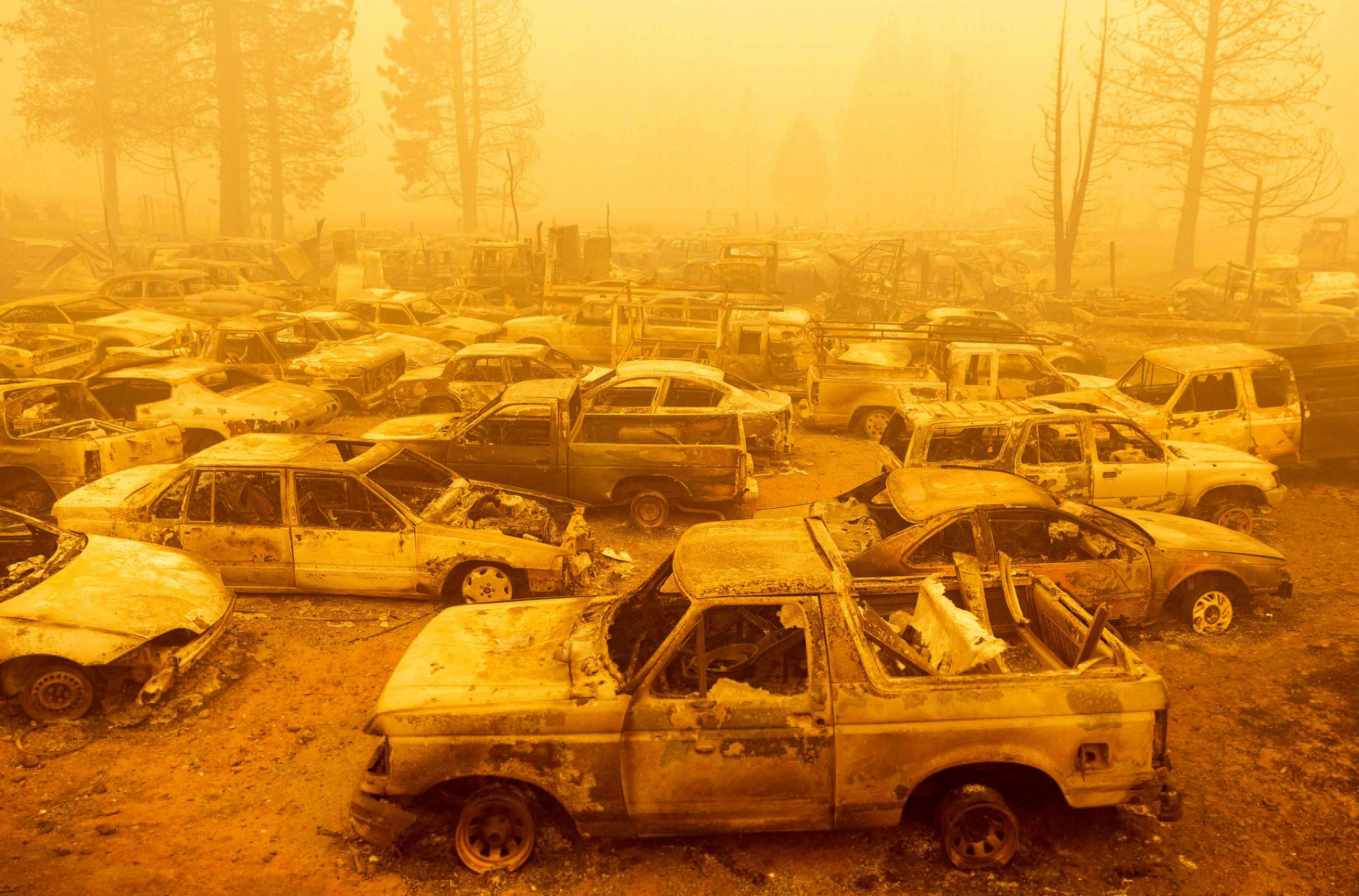 PHOTO: Dozens of burned vehicles rest in heavy smoke during the Dixie fire in Greenville, California, Aug. 6, 2021.