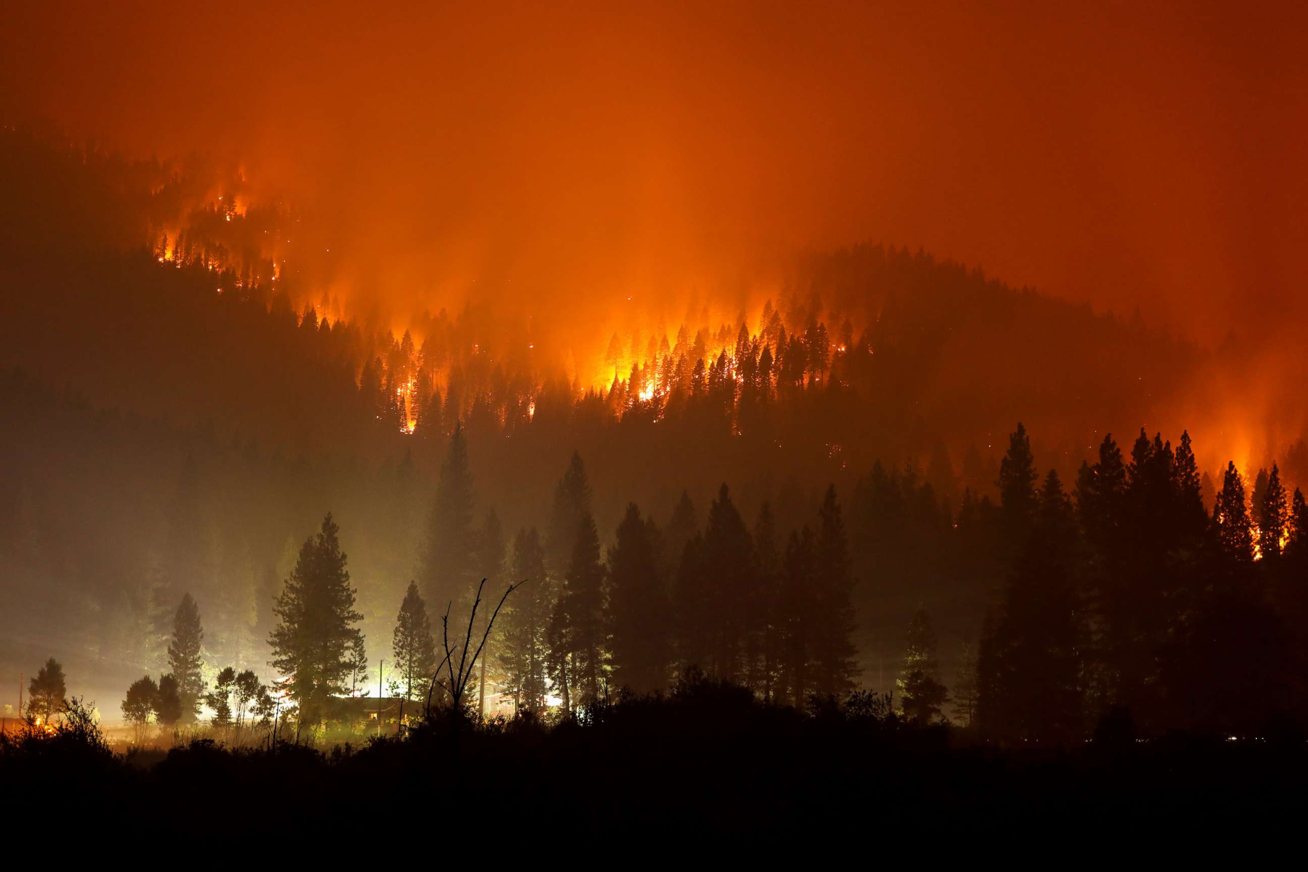 PHOTO: The Dixie Fire burns at night in Taylorsville, Calif., July 27, 2021.