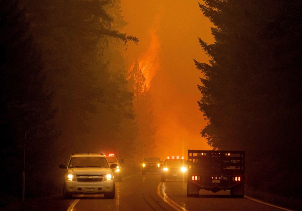 PHOTO: Firefighters monitor the scene as flames from the Dixie fire jump across highway 89 near Greenville, Calif., Aug. 3, 2021.