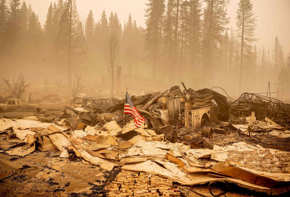 PHOTO: An American flag is placed on a burned fire engine at a burned fire station in downtown Greenville, California, Aug. 7, 2021.