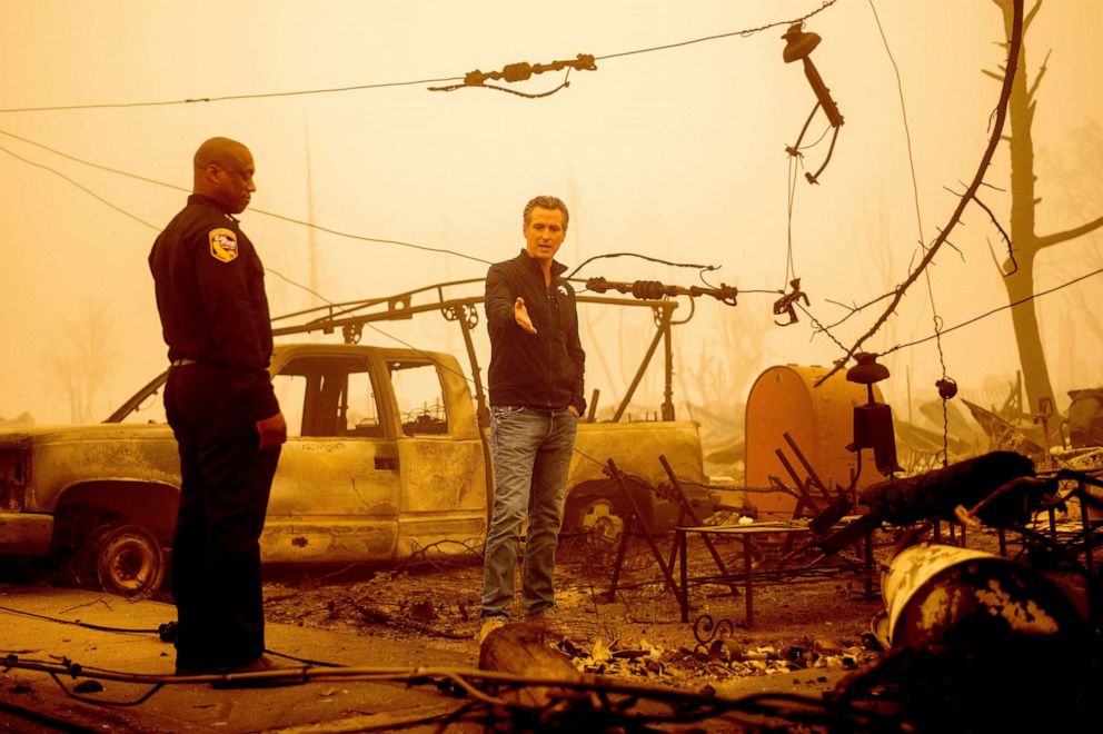 PHOTO: California Gov. Gavin Newsom examines a scorched utility pole while surveying Dixie Fire damage, Aug. 7, 2021, in Greenville, Calif.
