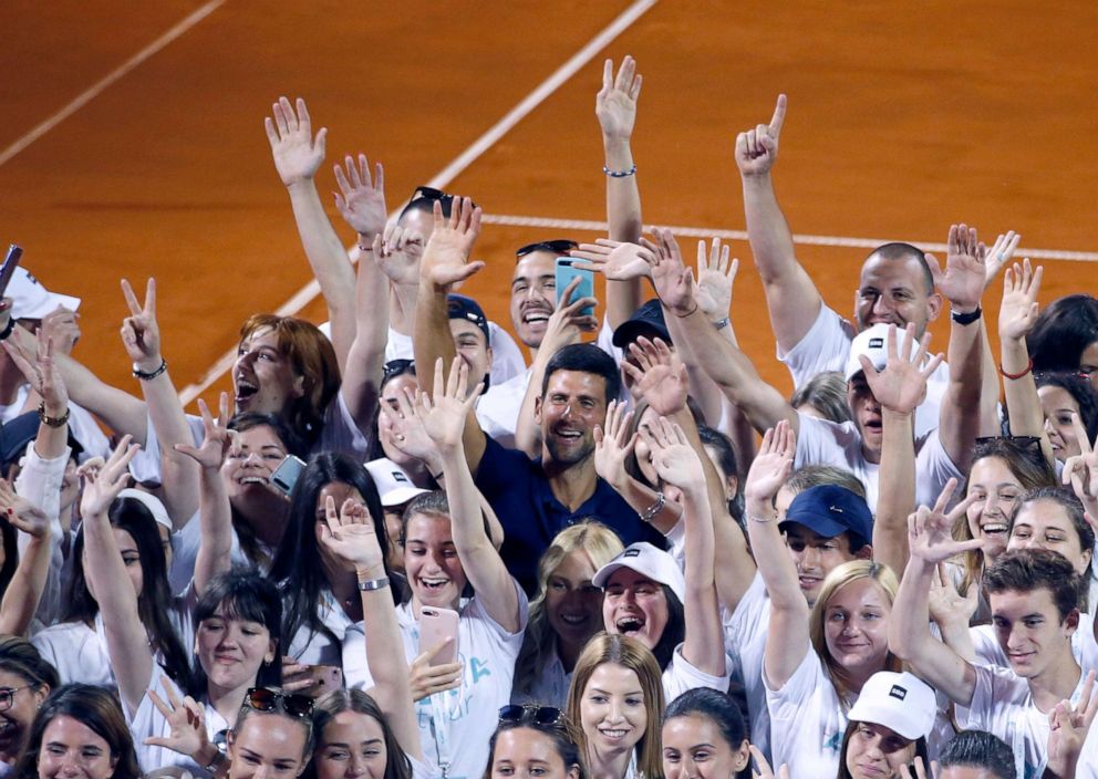 PHOTO: Serbia's Novak Djokovic, center, poses with volunteers and players after the Adria Tour charity tournament in Belgrade, Serbia, June 14, 2020.