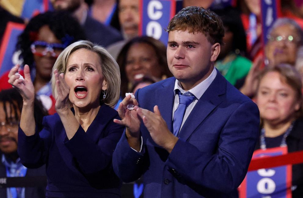 PHOTO: Tim Walz's wife Gwen Walz and their son Gus Walz cheer as he speaks on the third day of the Democratic National Convention, in Chicago, Aug. 21, 2024.